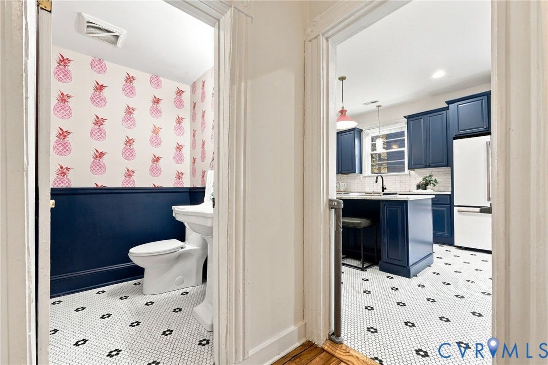 522 N 27th Street, Church Hill, Richmond, VA 23223 Half bath featuring a pedestal sink, patterned wallpaper, and navy wainscoting, with white and black hexagonal floor tile