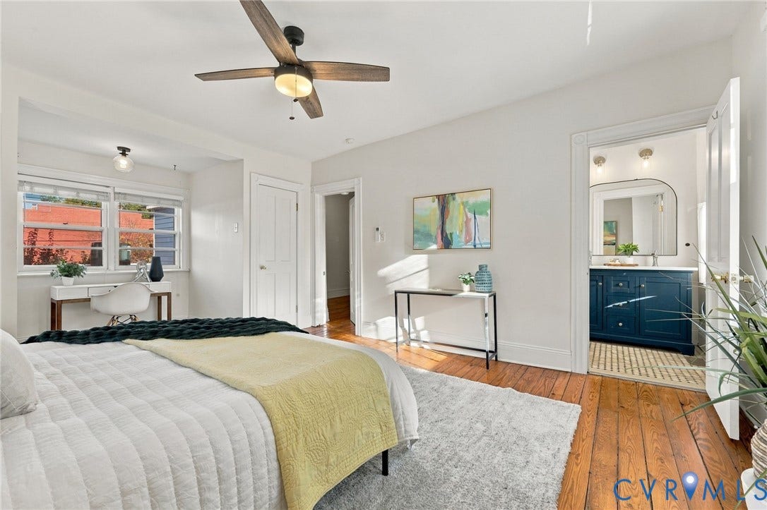 522 N 27th Street, Church Hill, Richmond, VA 23223 Hardwood flooring, ceiling fan with light fixture, multi-pane windows, and a bathroom featuring a navy blue vanity cabinet with a metallic faucet and arched mirror