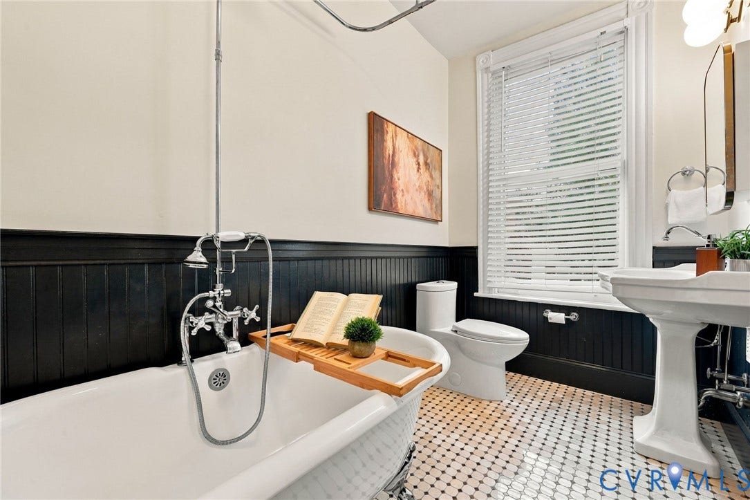 522 N 27th Street, Church Hill, Richmond, VA 23223 Hall full bath featuring lcawfoot soaking tub with exposed chrome plumbing fixtures, black beadboard wainscoting, pedestal sink, and geometric tile flooring