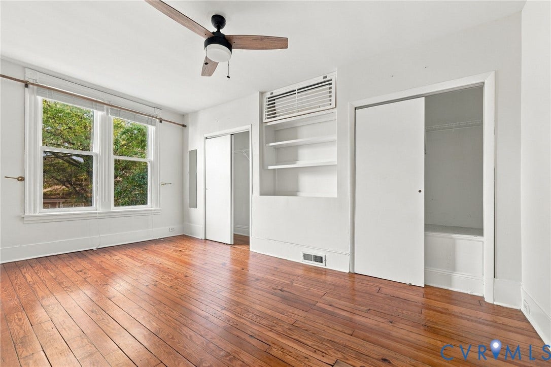 522 N 27th Street, Church Hill, Richmond, VA 23223 Front bedroom #2 featuring wood-finish flooring, a ceiling fan, built-in recessed shelving, dual-pane windows, and closet storage with sliding doors