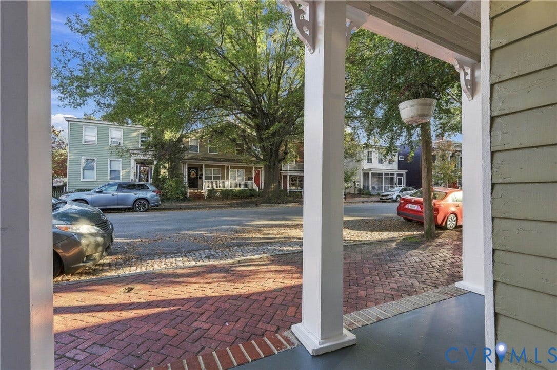 522 N 27th Street, Church Hill, Richmond, VA 23223 View of the street from the covered front porch featuring white support columns, horizontal lap siding, and a red brick herringbone walkway