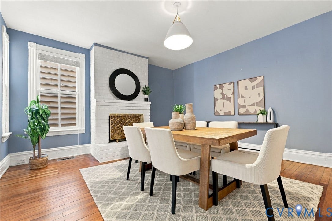 522 N 27th Street, Church Hill, Richmond, VA 23223 Painted brick fireplace with a metal fire screen, wood-finish flooring, and a pendant light fixture
