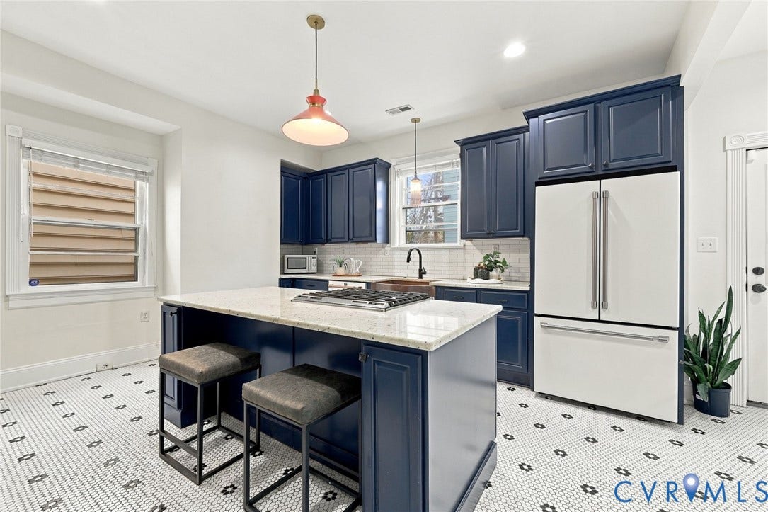 522 N 27th Street, Church Hill, Richmond, VA 23223 Kitchen featuring custom navy cabinetry, stone-surface island with an integrated gas cooktop, white subway tile backsplash, and decorative patterned floor tiling