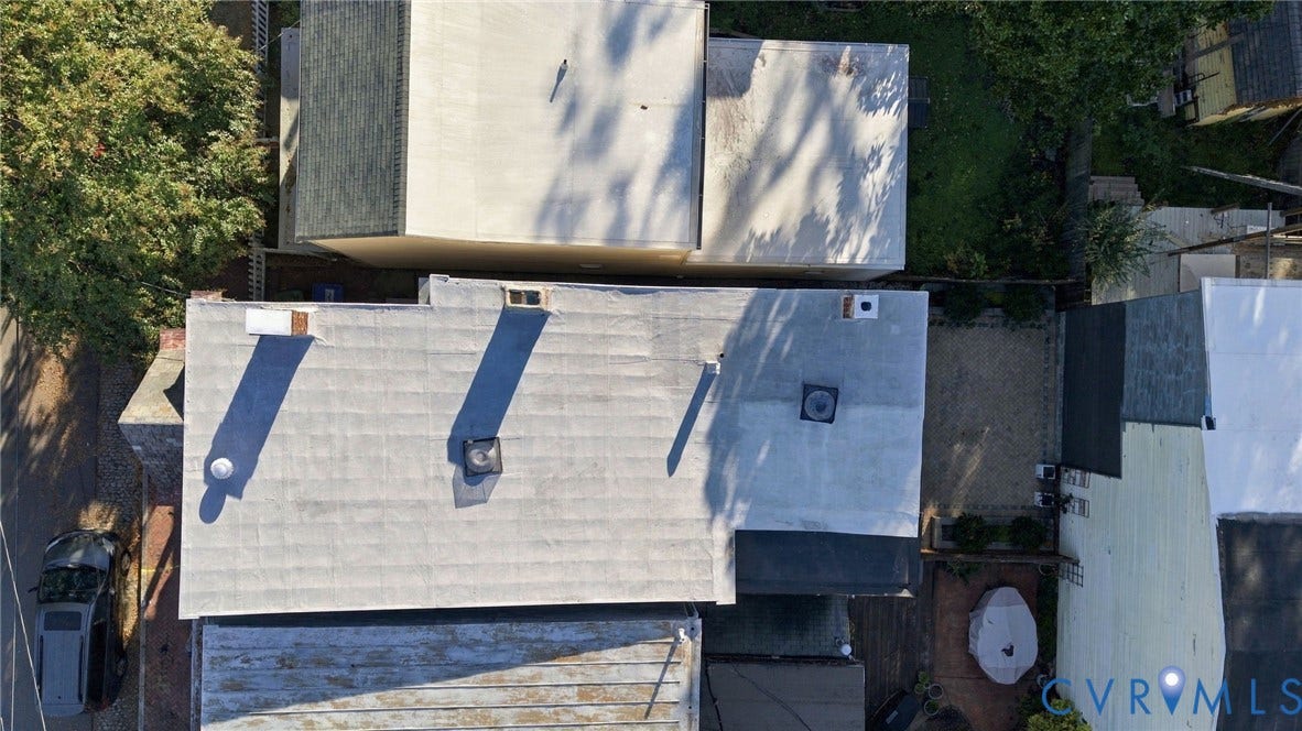 522 N 27th Street, Church Hill, Richmond, VA 23223 Aerial perspective of the property featuring a flat roof with chimney stacks, two ventilation units, and an area of gravel hardscaping