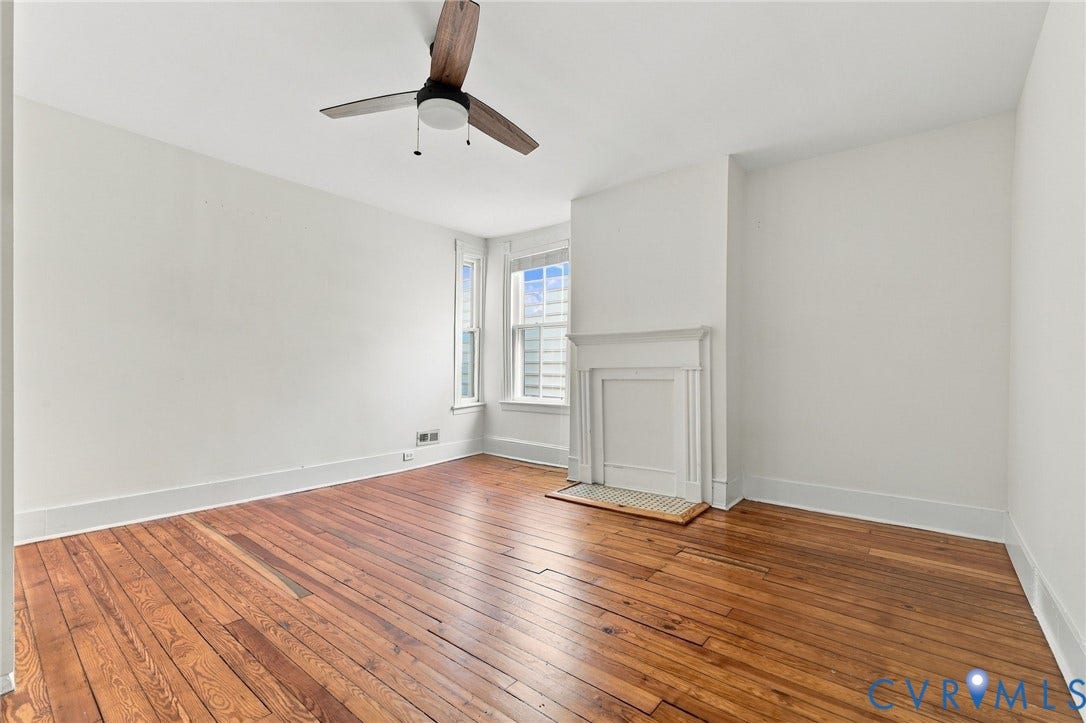 522 N 27th Street, Church Hill, Richmond, VA 23223 Bedroom #3 featuring wood-finish flooring, a white-mantel fireplace with a mosaic-tiled hearth, and a modern three-blade ceiling fan