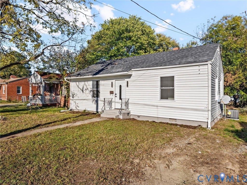 135 Elm Street, Petersburg, VA 23803 Single-story residence featuring light-colored horizontal siding, asphalt shingle roofing, and a front entryway with metal handrails