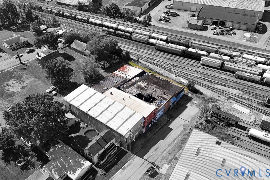109 E Oak Street, Covington, VA 24426 Aerial perspective of a multi-section commercial structure featuring a combination of metal and flat roofing, brick exterior walls, and immediate proximity to rail infrastructure