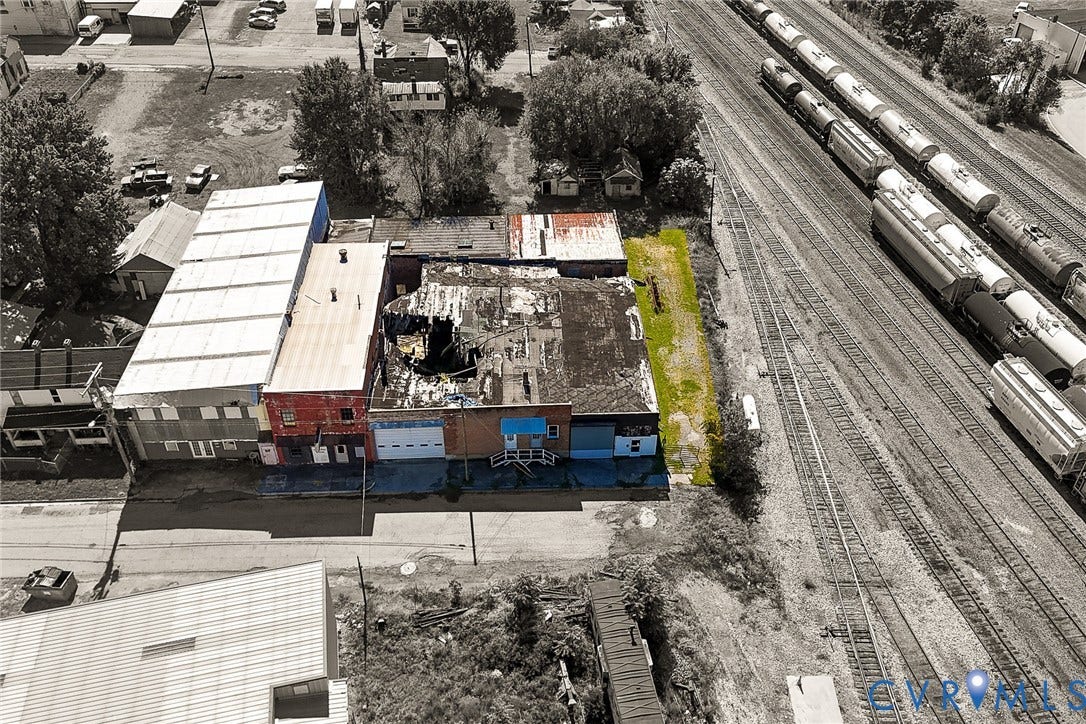 109 E Oak Street, Covington, VA 24426 Aerial perspective of a multi-section commercial structure featuring a combination of brick and metal siding exterior finishes, multiple street-level access points, and a dedicated strip of exterior land