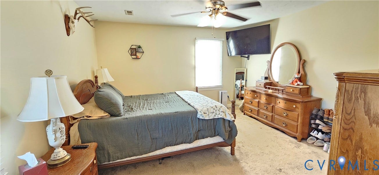 8605 Howerton Road, Center Cross, VA 22437 Bedroom featuring neutral wall paint, carpeted flooring, and a ceiling fan with integrated lighting