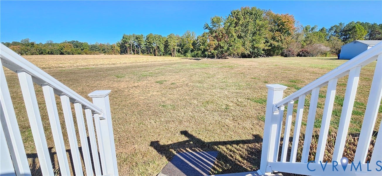 8605 Howerton Road, Center Cross, VA 22437 Expansive lot featuring white vinyl railings, open acreage, and mature tree line
