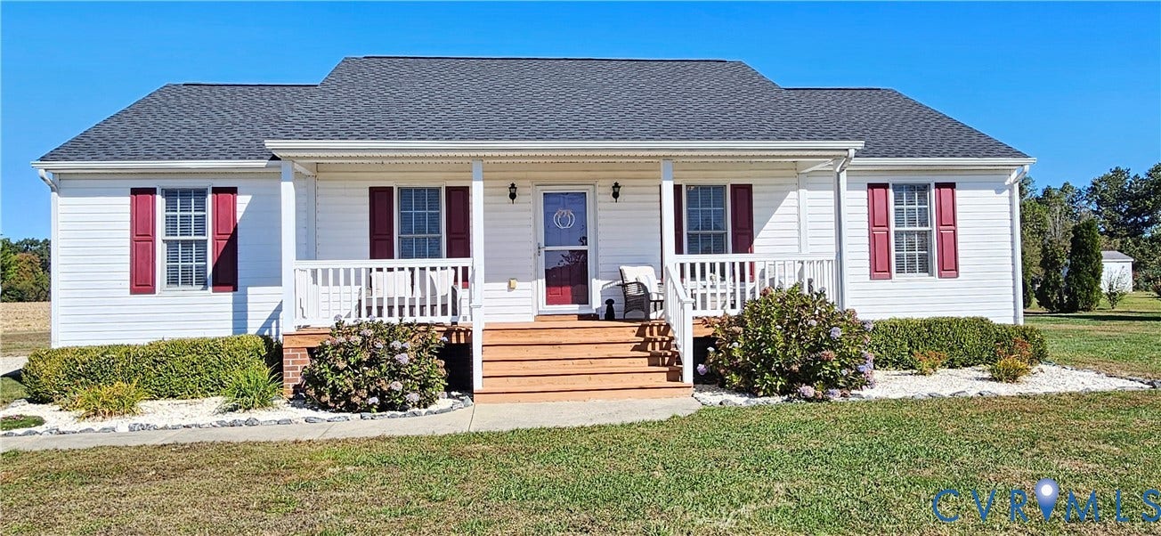 8605 Howerton Road, Center Cross, VA 22437 Single-story residence featuring white horizontal siding, a covered front porch with wood-finish decking, dark red louvered shutters, and a shingled roof