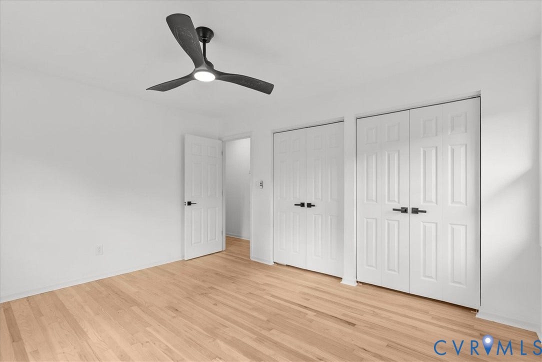 4942 Pleasant Shade Drive, Emporia, Emporia, VA 23847 Wood-finish flooring, three-blade ceiling fan with integrated lighting, and white six-panel doors with matte black hardware
