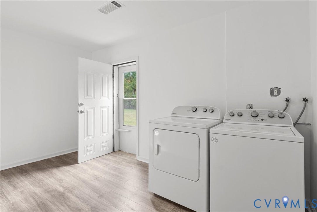 4942 Pleasant Shade Drive, Emporia, Emporia, VA 23847 Utility room featuring wood-finish flooring, a white paneled door, a single-lite glass exterior door, and dedicated laundry hookups