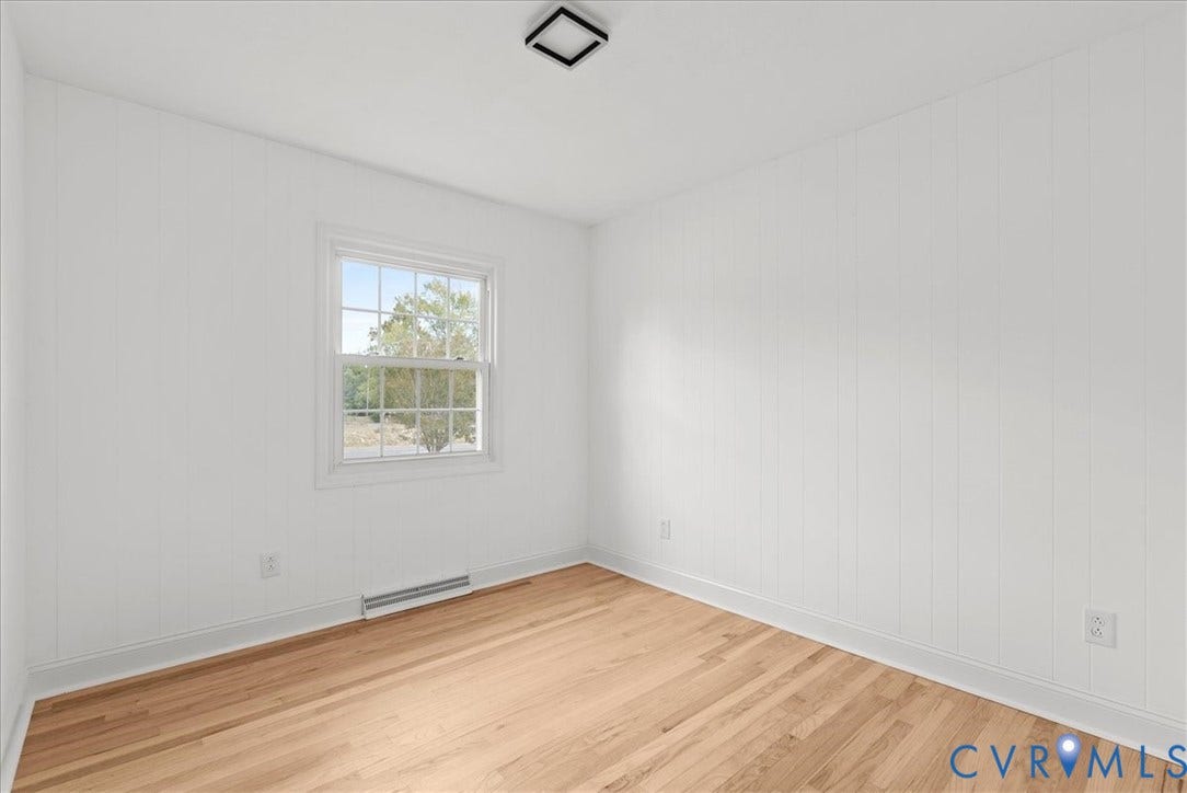 4942 Pleasant Shade Drive, Emporia, Emporia, VA 23847 Interior space featuring white vertical paneled walls, wood-finish flooring, a multi-pane window, and a square flush-mount ceiling light