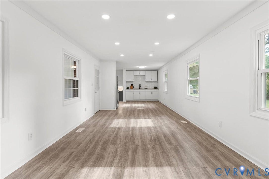 4942 Pleasant Shade Drive, Emporia, Emporia, VA 23847 Open interior featuring wood-finish flooring, recessed lighting, white cabinetry, a tiled backsplash, and dual-pane windows
