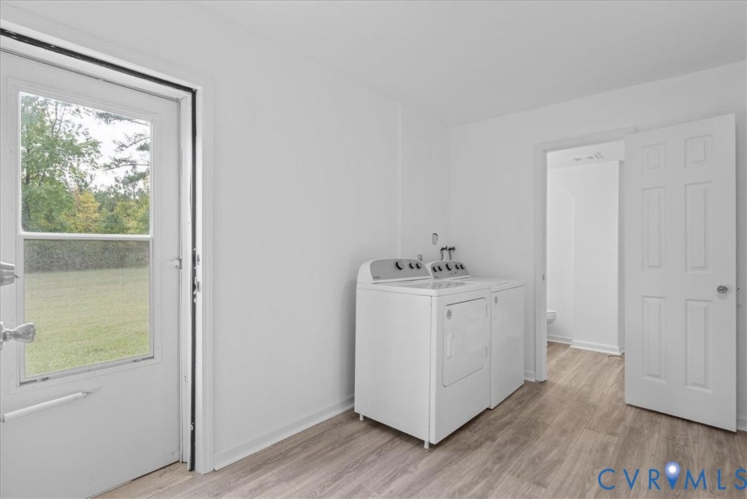 4942 Pleasant Shade Drive, Emporia, Emporia, VA 23847 Laundry room featuring wood-finish flooring, a six-panel interior door, and a glass-inset exterior door