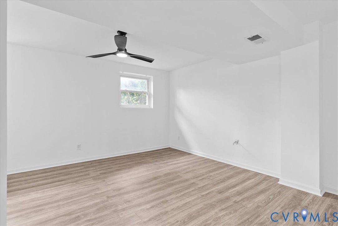 4942 Pleasant Shade Drive, Emporia, Emporia, VA 23847 Interior room featuring wood-finish flooring, white walls, and a modern ceiling fan with integrated lighting