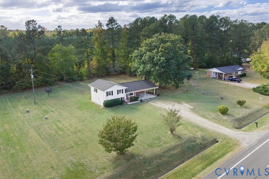 4942 Pleasant Shade Drive, Emporia, Emporia, VA 23847 Single-story residence featuring a covered carport, light-colored siding, dark shingled roof, expansive lot, and mature tree-lined perimeter