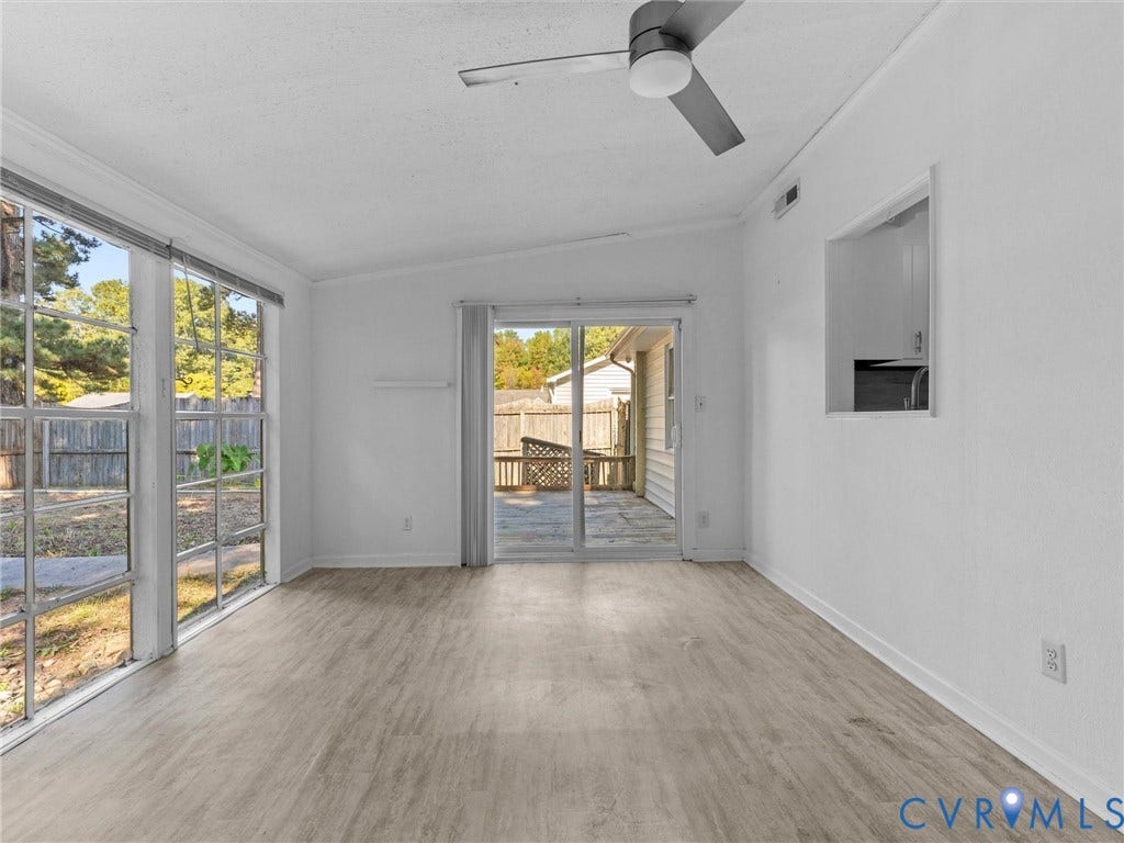 503 Briarwood Circle, Jefferson Circle, North Prince George, VA 23860 Bright room featuring wood-finish flooring, ceiling fan, large windows, and a sliding glass door providing access to the patio