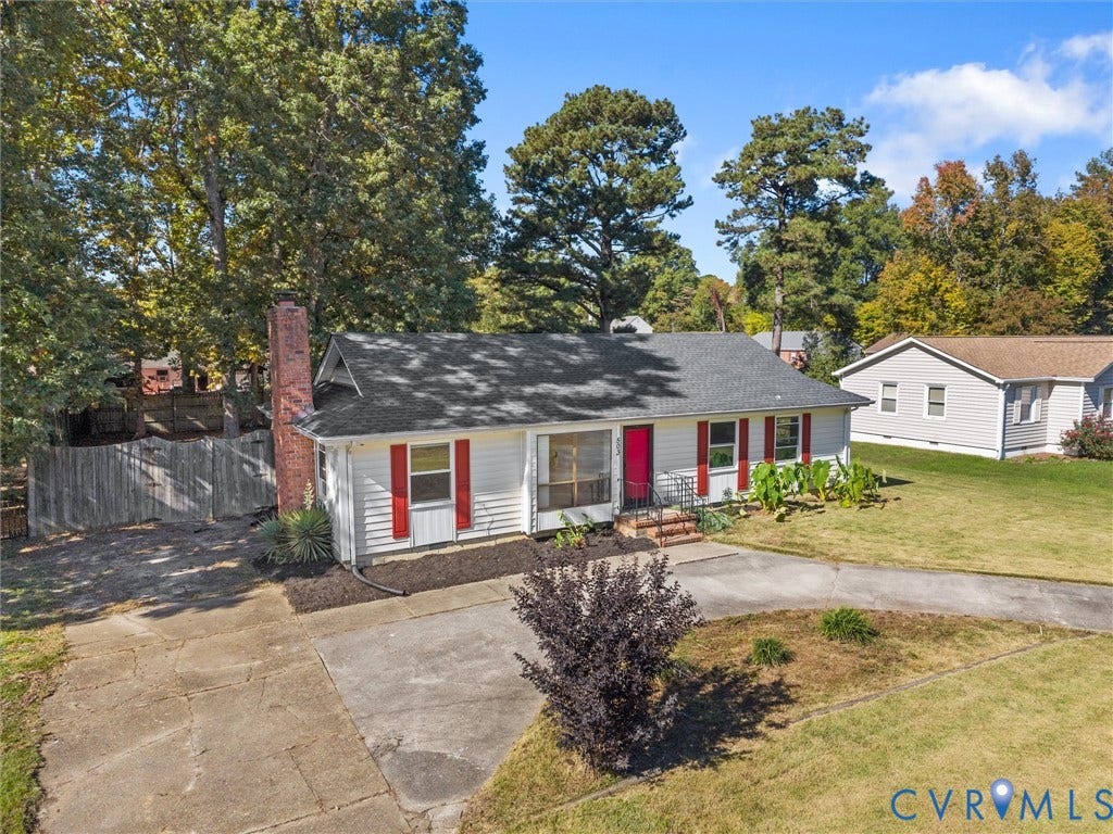 503 Briarwood Circle, Jefferson Circle, North Prince George, VA 23860 Single-story residence featuring horizontal white siding, a contrasting chimney exterior, red window shutters, a concrete driveway, and mature perimeter trees