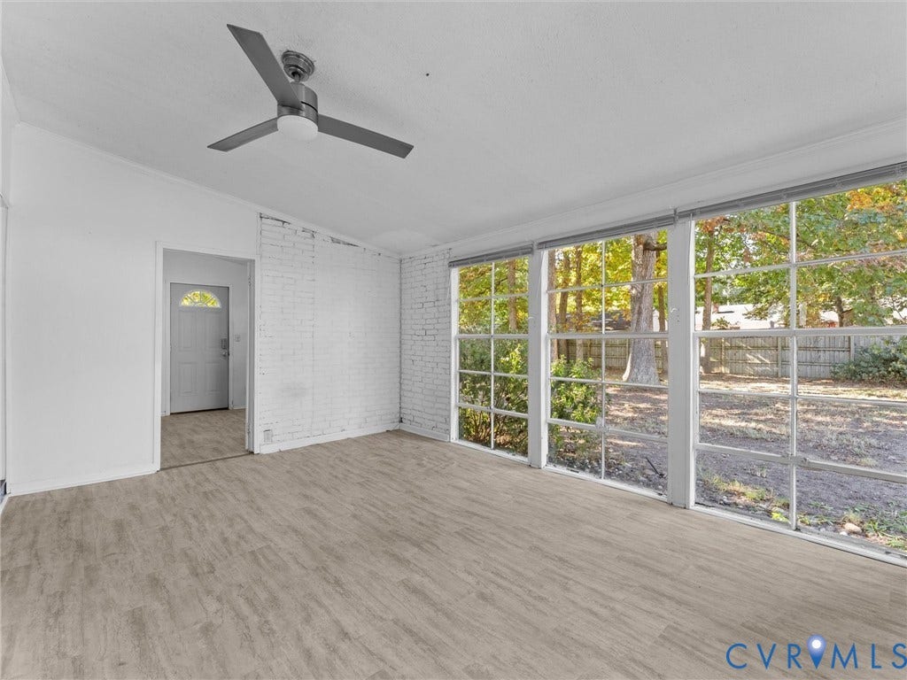 503 Briarwood Circle, Jefferson Circle, North Prince George, VA 23860 Room featuring wood-finish flooring, white painted brick walls, multi-pane windows, and a ceiling-mounted light fixture
