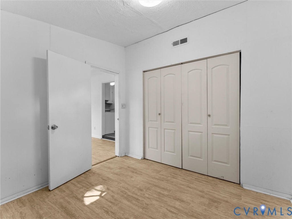 503 Briarwood Circle, Jefferson Circle, North Prince George, VA 23860 Interior space featuring wood-finish flooring, white walls, and a multi-panel door closet with chrome hardware