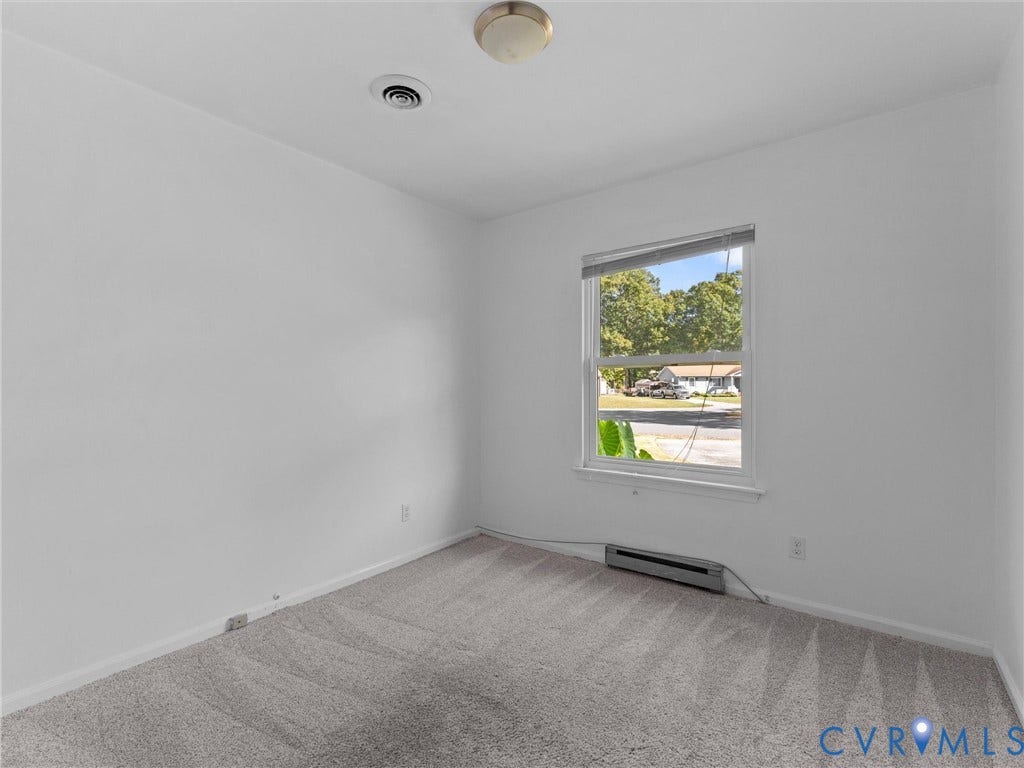 503 Briarwood Circle, Jefferson Circle, North Prince George, VA 23860 Neutral-toned carpeted flooring, single-pane window with a horizontal blind, and a flush-mount ceiling light fixture
