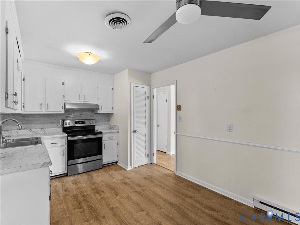 503 Briarwood Circle, Jefferson Circle, North Prince George, VA 23860 Kitchen featuring white cabinetry, stone-finish laminate countertops, stainless steel range with overhead hood, wood-finish flooring, and ceiling fan with integrated lighting