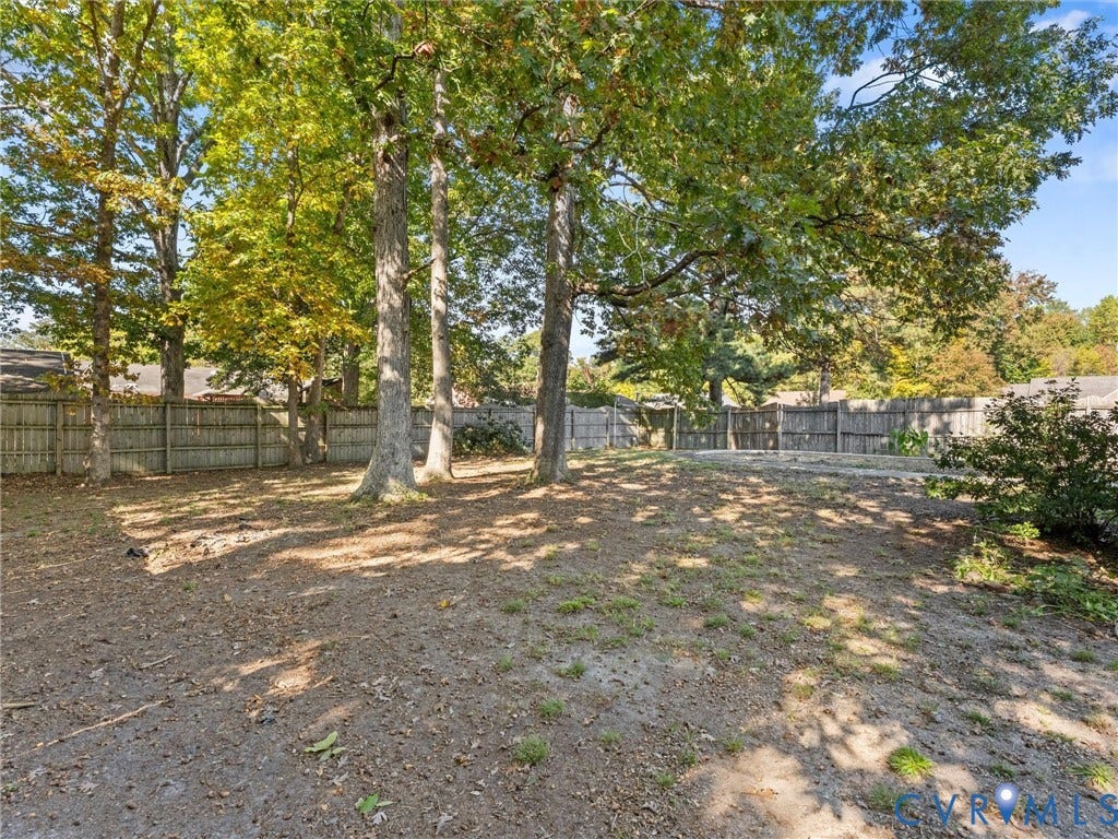 503 Briarwood Circle, Jefferson Circle, North Prince George, VA 23860 Backyard space featuring mature trees and wood-panel perimeter fencing