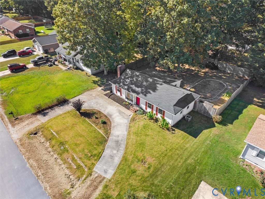 503 Briarwood Circle, Jefferson Circle, North Prince George, VA 23860 Single-story residence featuring light-colored siding, a pitched roof, a curved concrete driveway, a chimney, and a fenced backyard with mature trees