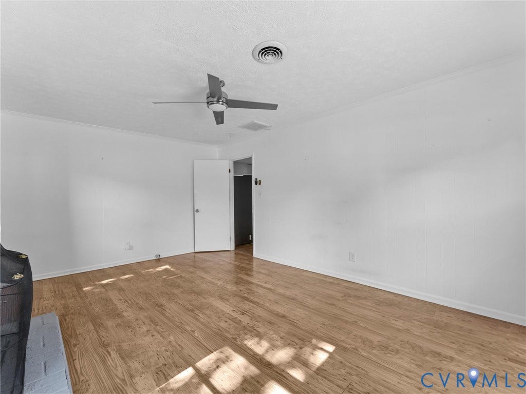 503 Briarwood Circle, Jefferson Circle, North Prince George, VA 23860 Interior space featuring wood-finish flooring, a ceiling fan with integrated lighting, and a painted brick hearth