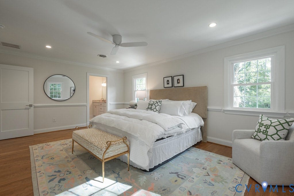Bedroom interior featuring wood-finish flooring, wainscoting, recessed lighting, a ceiling fan, and double-hung windows