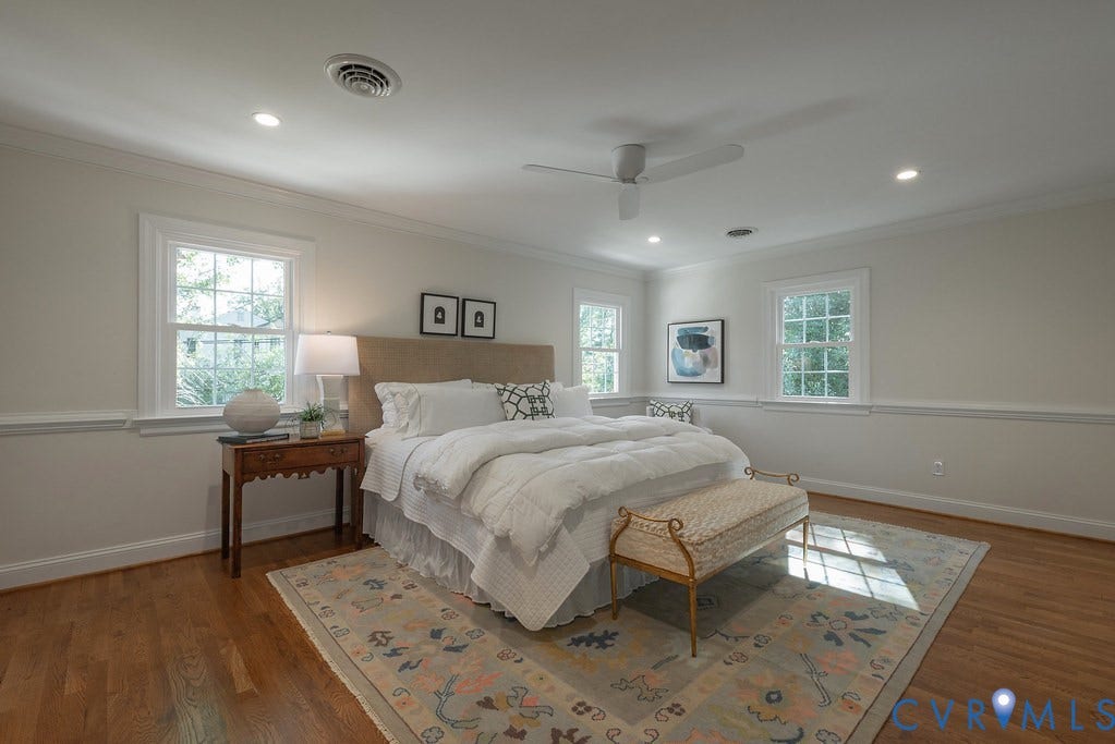 Spacious room featuring wood-finish flooring, white chair rail molding, a neutral color palette, recessed lighting, and a ceiling fan