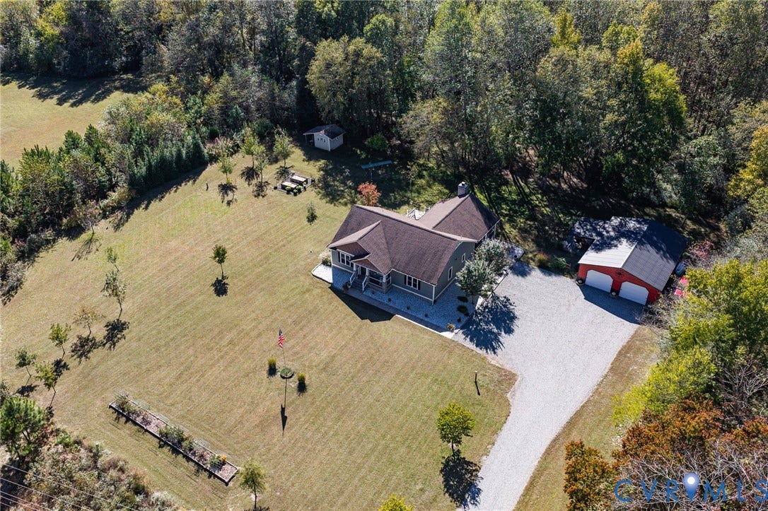 3820 Upshaw Road, Decker's Pond, Aylett, VA 23009 Expansive parcel featuring a detached two-car garage, gravel driveway, mature perimeter trees, and a rectangular garden bed