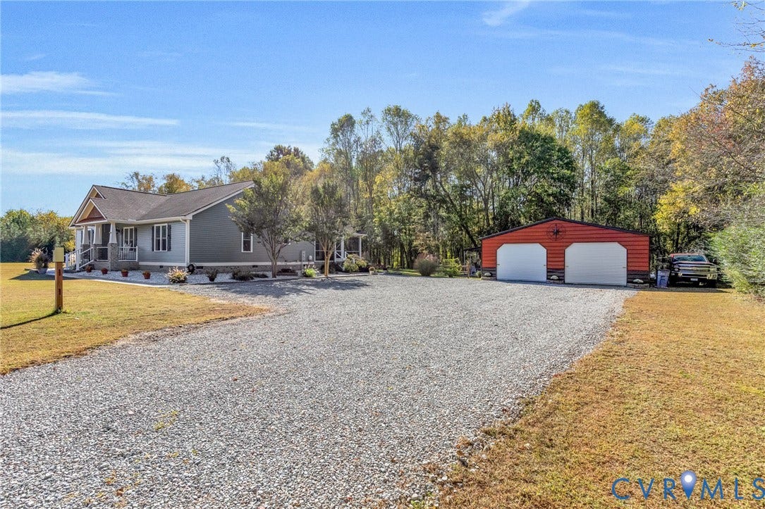 3820 Upshaw Road, Decker's Pond, Aylett, VA 23009 Single-story residence with lap siding, covered front porch, stone-veneer foundation accents, gravel driveway, and detached two-car garage