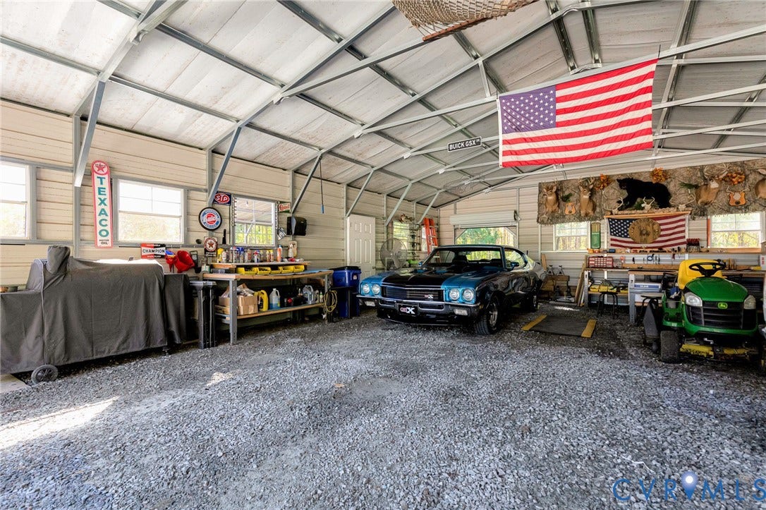 3820 Upshaw Road, Decker's Pond, Aylett, VA 23009 Detached metal-frame workshop featuring a gravel floor, exposed vaulted ceiling structure, and multiple windows