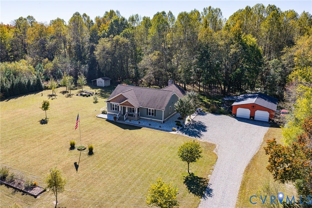3820 Upshaw Road, Decker's Pond, Aylett, VA 23009 Exterior featuring a gabled roofline, lap siding, a two-car detached garage, a gravel driveway, and an expansive lawn