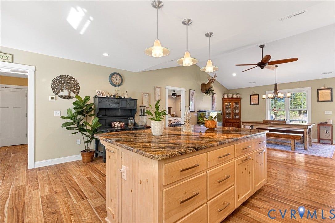 3820 Upshaw Road, Decker's Pond, Aylett, VA 23009 Kitchen featuring a natural stone countertop island, light-finish cabinetry, vaulted ceilings, three pendant lights, and wood-finish flooring