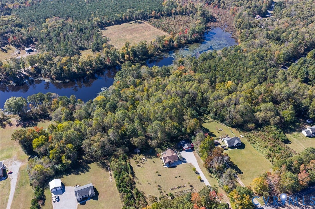 3820 Upshaw Road, Decker's Pond, Aylett, VA 23009 Aerial perspective featuring extensive tree coverage, expansive acreage, and water frontage on a natural pond