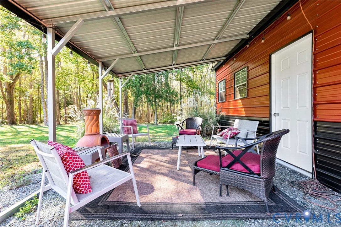 3820 Upshaw Road, Decker's Pond, Aylett, VA 23009 Covered outdoor patio with a metal roof, two-tone metal exterior siding, and gravel flooring