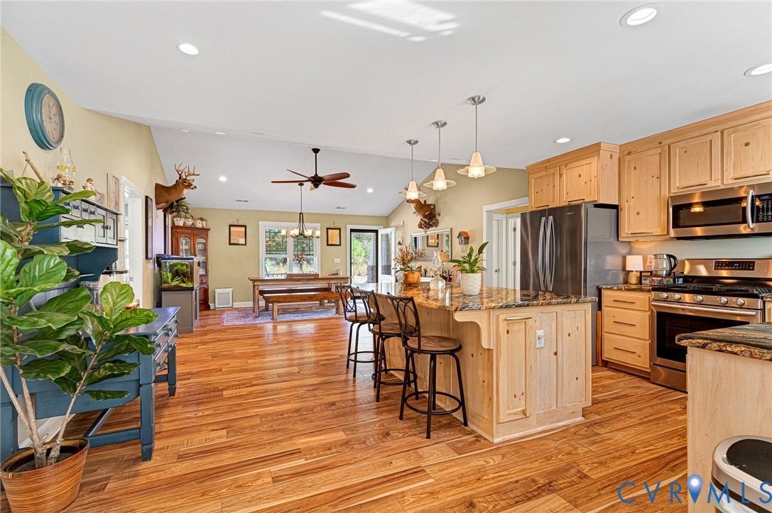 3820 Upshaw Road, Decker's Pond, Aylett, VA 23009 Open-concept kitchen featuring natural wood cabinetry, a central island with a stone-surface countertop, stainless steel appliances, recessed ceiling lighting, and wood-finish flooring