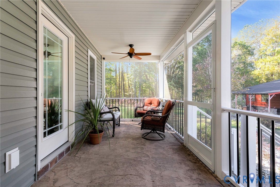 3820 Upshaw Road, Decker's Pond, Aylett, VA 23009 Screened porch featuring a stamped concrete floor, horizontal siding, and a ceiling-mounted fan with light fixture