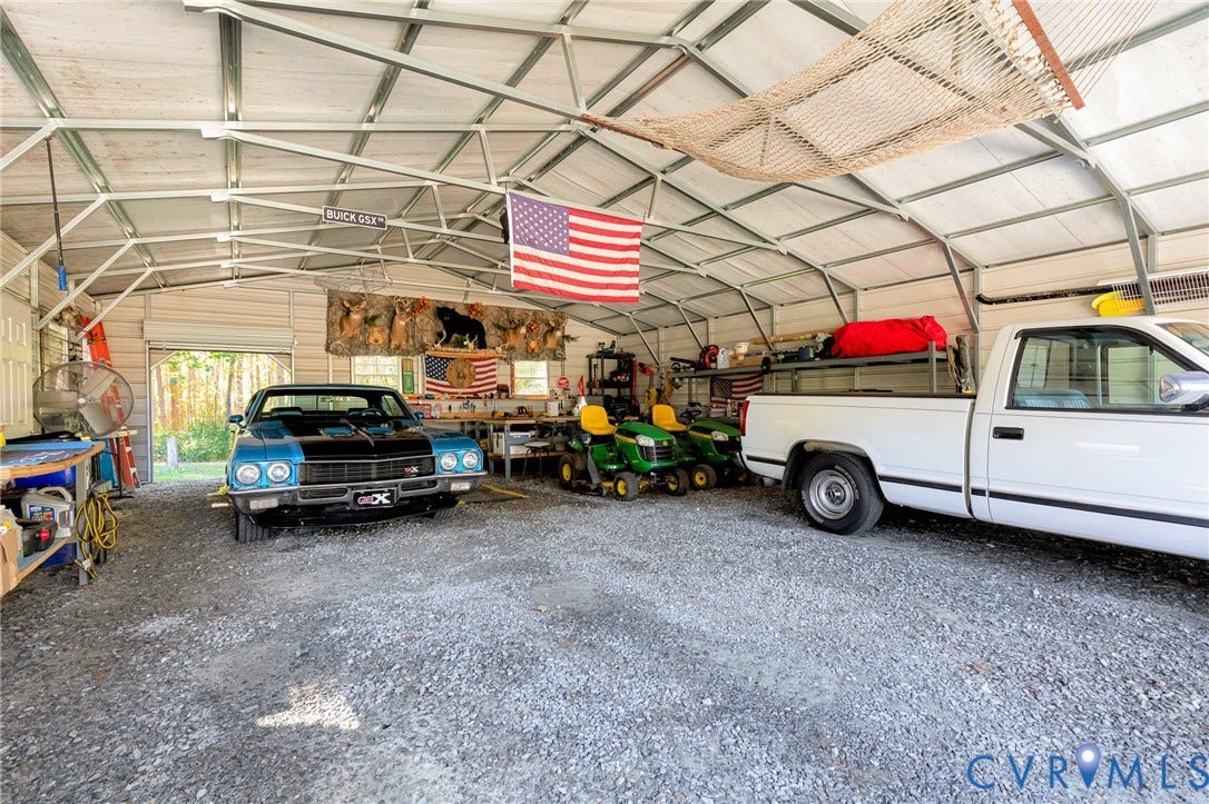 3820 Upshaw Road, Decker's Pond, Aylett, VA 23009 Detached metal-frame storage building with an open-span interior, metal roof, and gravel flooring