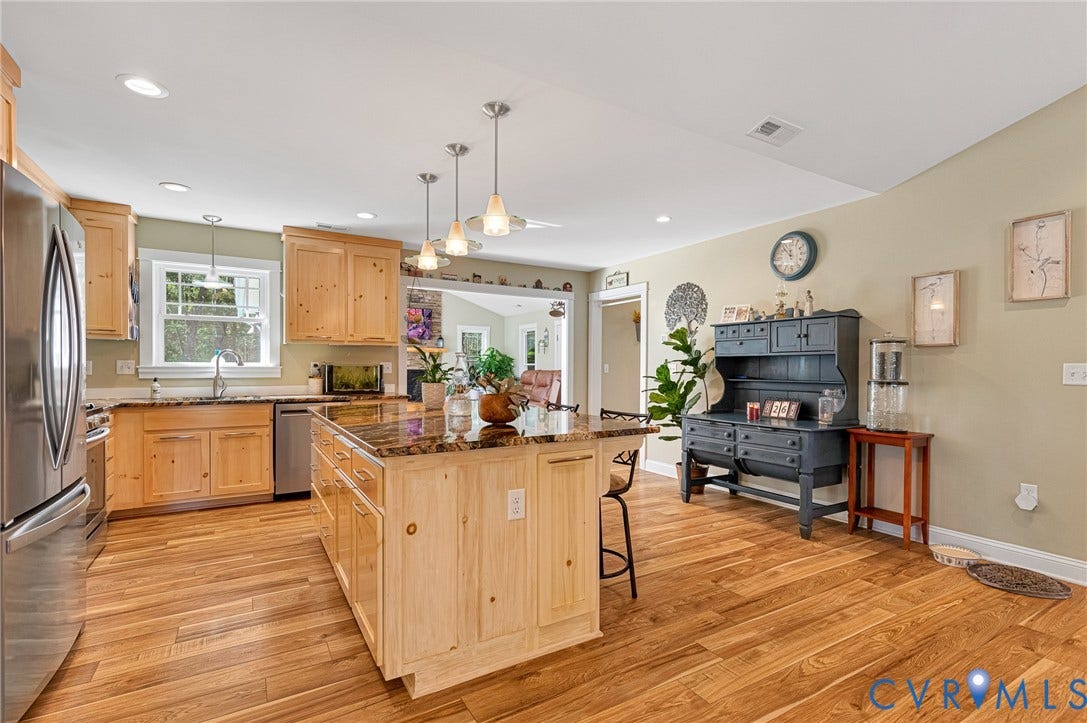3820 Upshaw Road, Decker's Pond, Aylett, VA 23009 Kitchen featuring natural finish wood cabinetry, stone countertops, a central island with pendant lighting, stainless steel appliances, and wood-finish flooring