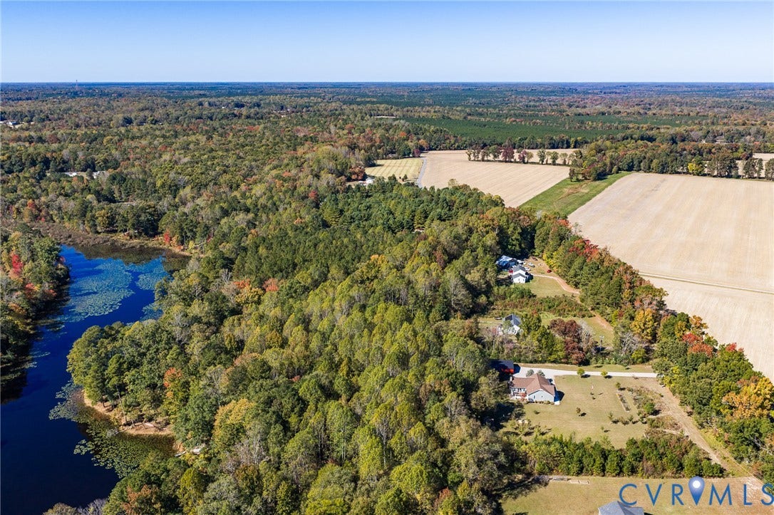 3820 Upshaw Road, Decker's Pond, Aylett, VA 23009 Aerial perspective of rural acreage featuring a natural water body, expansive woodland, and open fields
