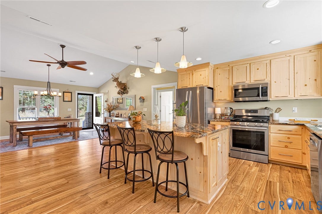3820 Upshaw Road, Decker's Pond, Aylett, VA 23009 Kitchen featuring light-tone wood cabinetry, natural stone countertops, stainless steel appliances, pendant lighting, and wood-finish flooring