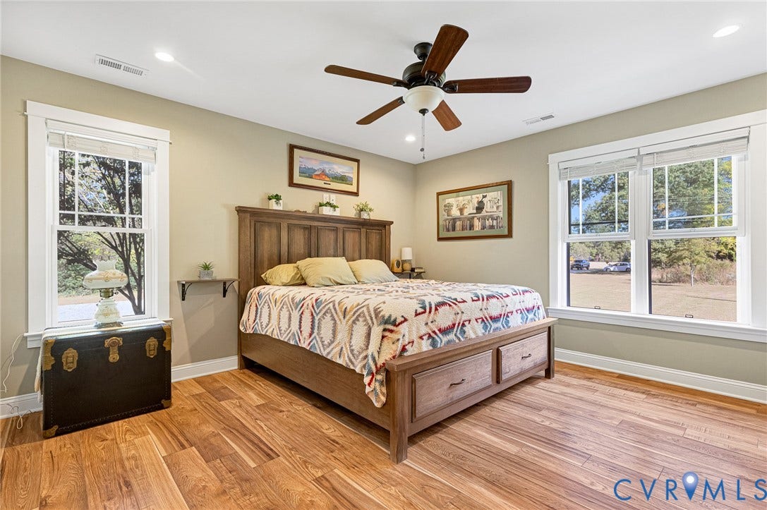 3820 Upshaw Road, Decker's Pond, Aylett, VA 23009 Neutral-toned bedroom featuring wood-finish flooring, recessed lighting, a ceiling fan with integrated light, and large windows with white trim