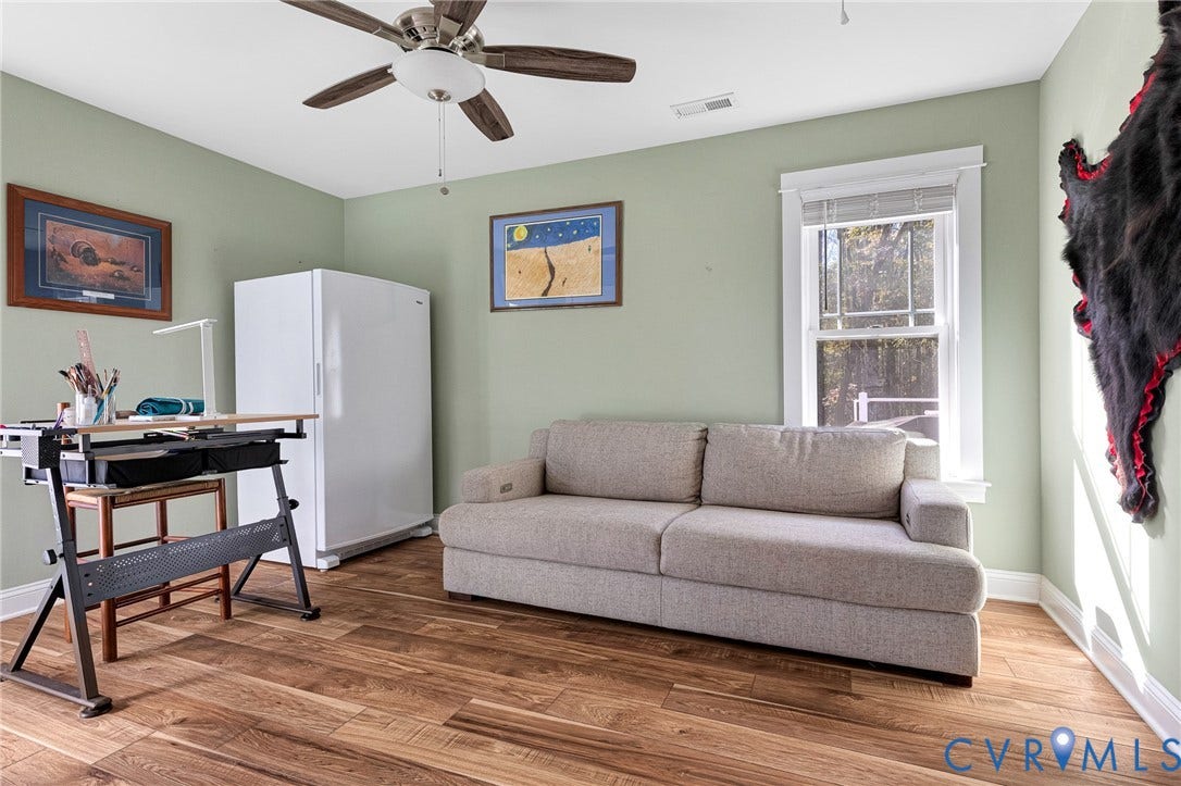 3820 Upshaw Road, Decker's Pond, Aylett, VA 23009 Wood-finish flooring, ceiling fan with integrated lighting, and white-trimmed window