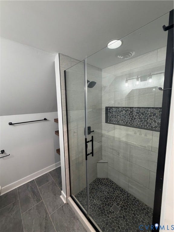 2305 Lydell Drive, Ginter Park - Adjacent, Glen Allen, VA 23228 Walk-in shower featuring a frameless glass door, stone-tile flooring, horizontal wall tiling, integrated shelving niche, and matte black fixtures