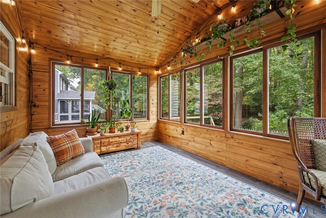 Sunroom featuring natural wood paneling, vaulted tongue-and-groove ceiling, and large picture windows